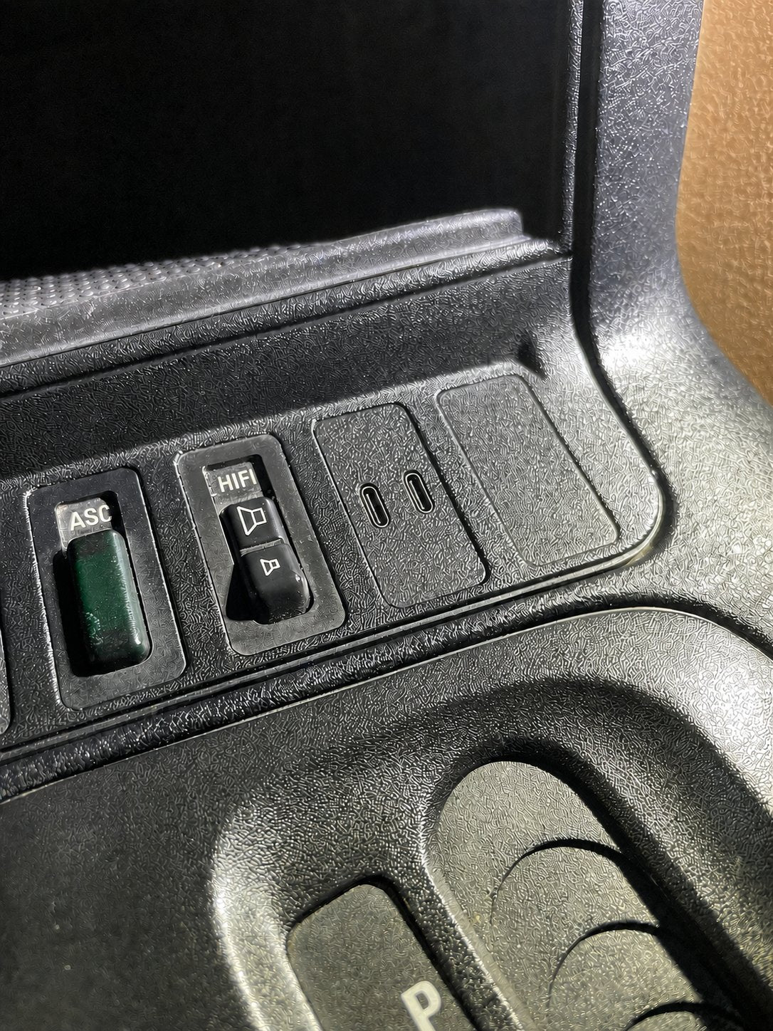 Dual USB-C quick-charge module installed in a BMW E36 center console