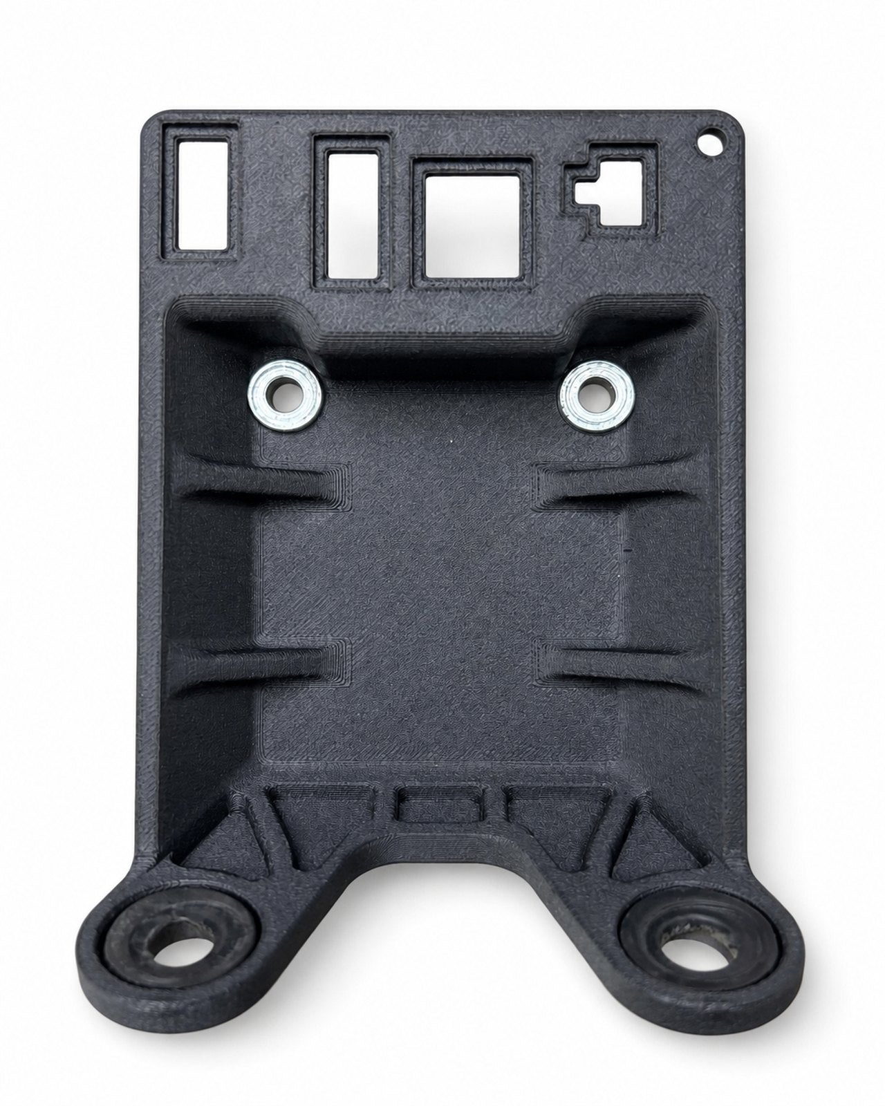 Black mounting bracket with metal inserts and a contoured profile