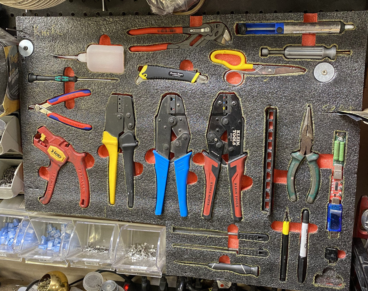 Compact foam tool panel with cutouts for crimpers, pliers, scissors, and small hand tools